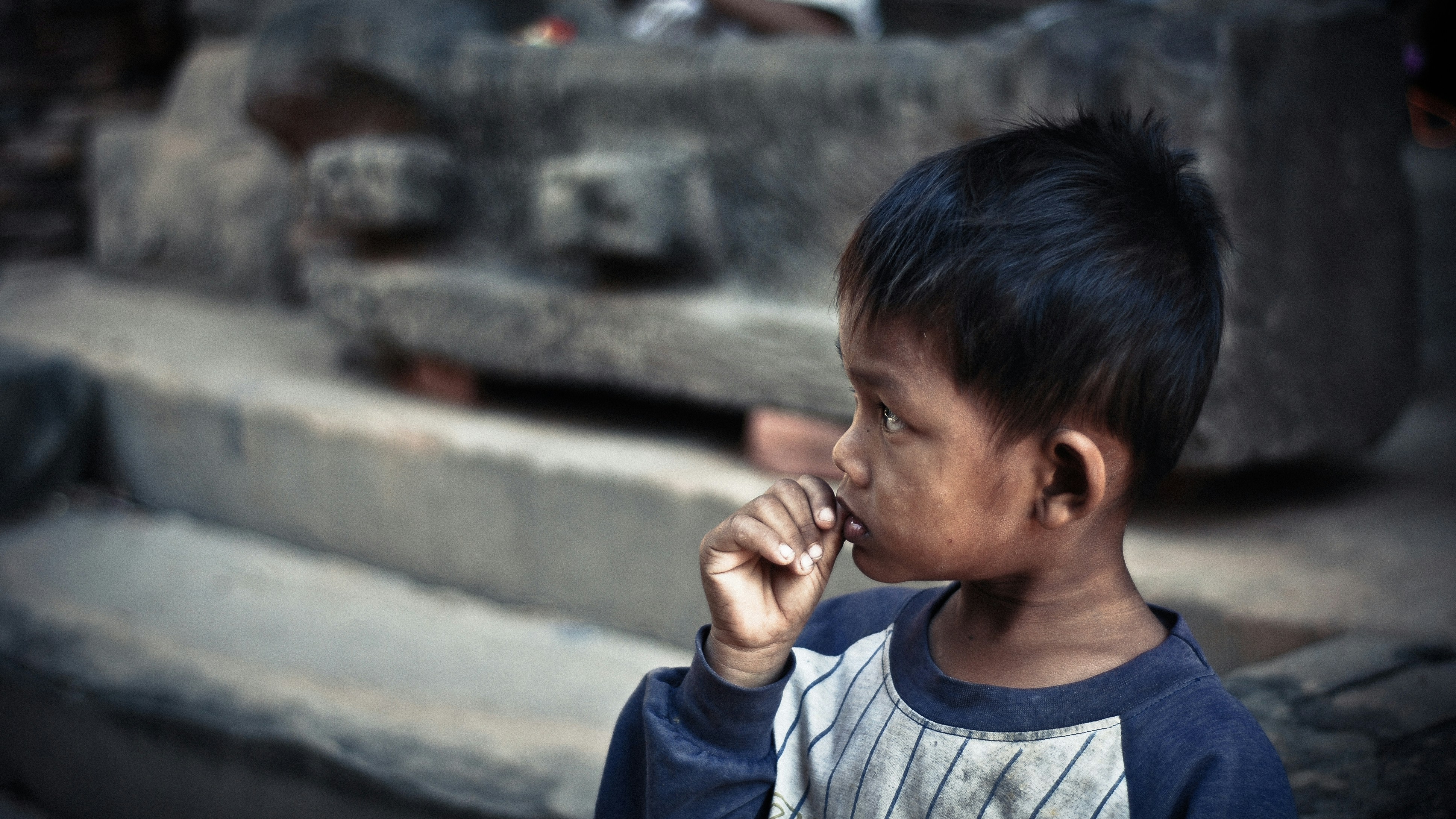 Young boy in contemplative profile view