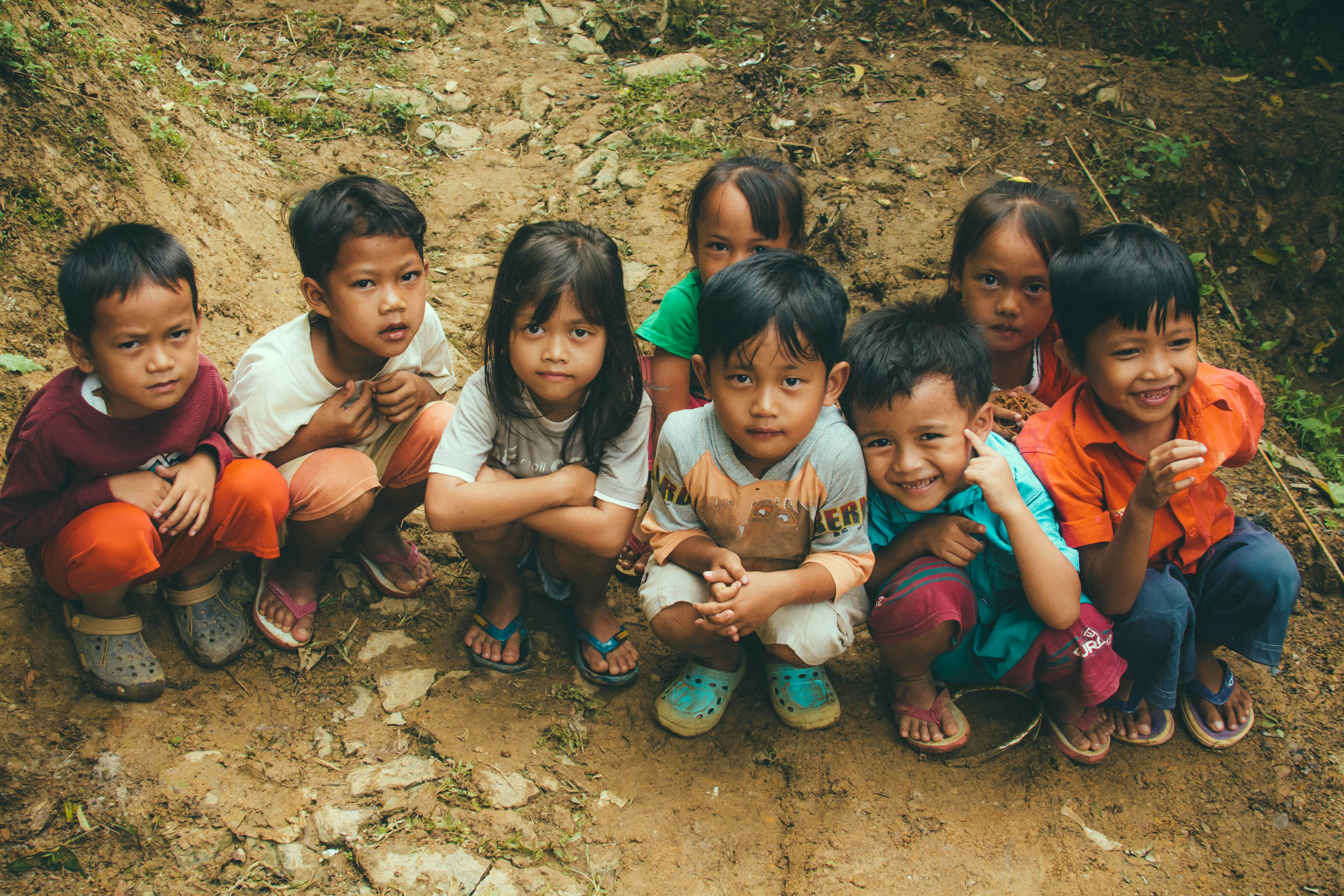 Group of children sitting together on ground